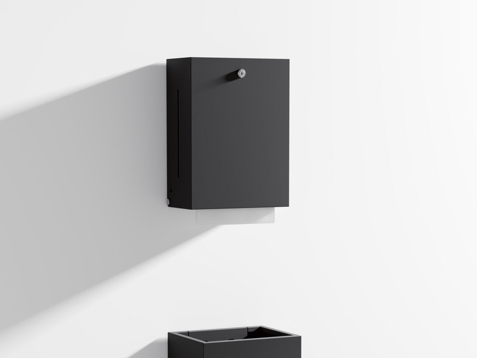 HEWI paper towel dispenser and waste bin in matt black Paper towel dispenser and waste bin with angular design in matt black stainless steel