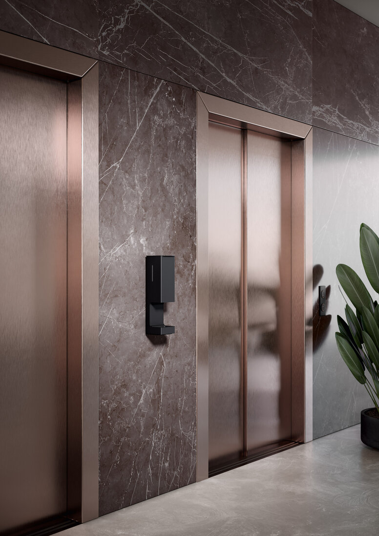 HEWI SENSORIC disinfectant dispenser wall model A touch-free disinfectant dispenser is installed on the wall between two lift doors